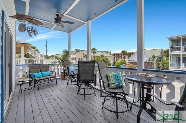 deck with a residential view and a ceiling fan