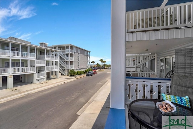 exterior space featuring sidewalks, stairway, and curbs