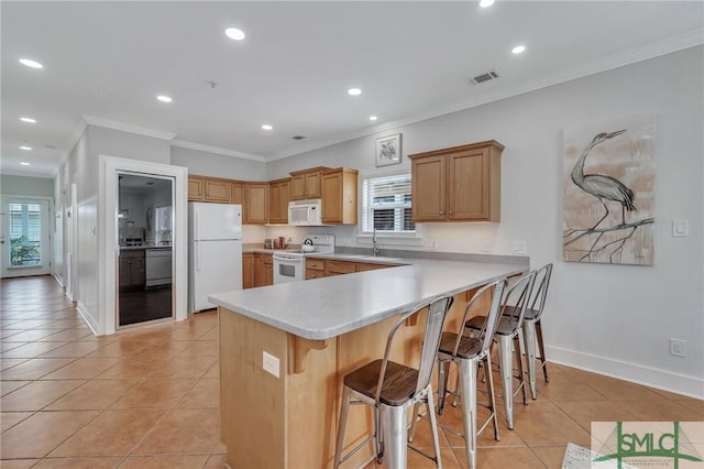 kitchen featuring light tile patterned floors, white appliances, a peninsula, and ornamental molding