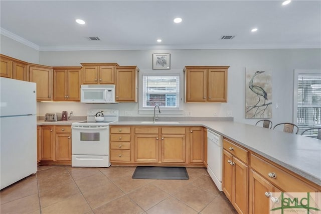 kitchen featuring crown molding, light countertops, light tile patterned floors, white appliances, and a sink