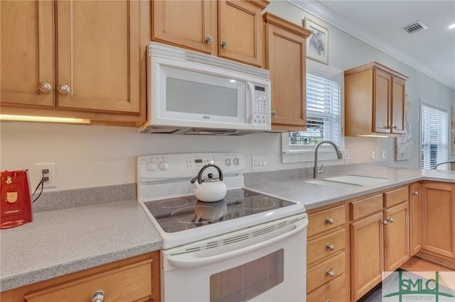 kitchen with visible vents, crown molding, light countertops, white appliances, and a sink