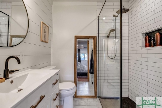 bathroom with ensuite bath, vanity, and a tile shower