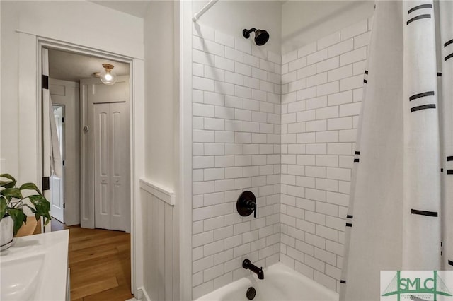 full bathroom featuring wood finished floors and shower / bath combo