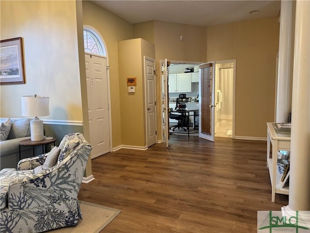 entryway with baseboards and dark wood-style flooring