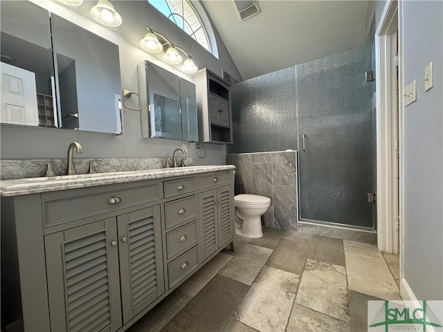 bathroom with visible vents, double vanity, a stall shower, tile walls, and toilet