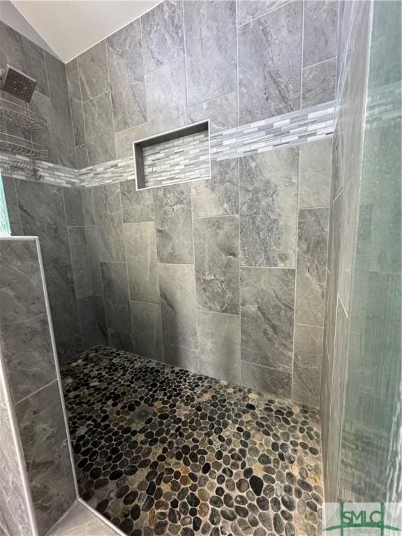 full bath featuring a tile shower