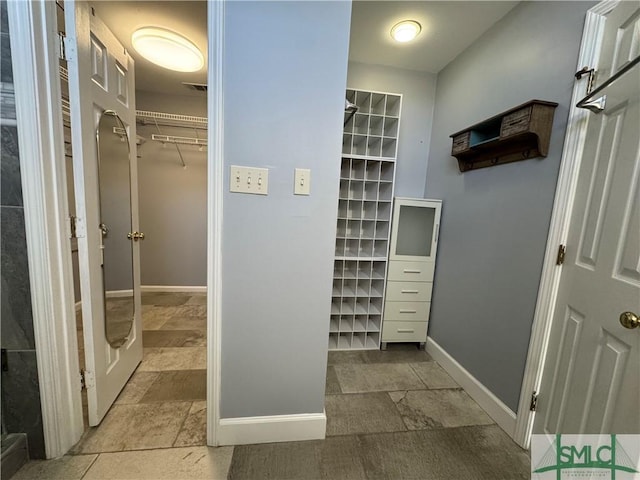 spacious closet with stone finish flooring