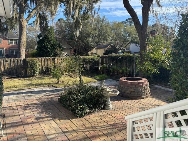 view of patio / terrace with fence private yard and an outdoor fire pit