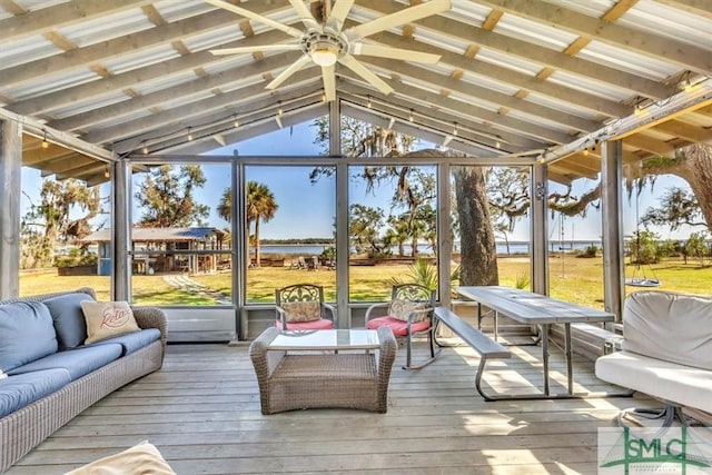 sunroom with vaulted ceiling and a ceiling fan