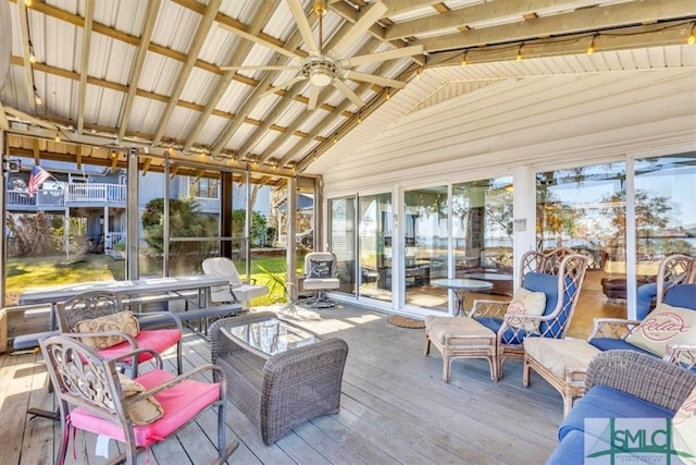 sunroom / solarium with vaulted ceiling and a ceiling fan