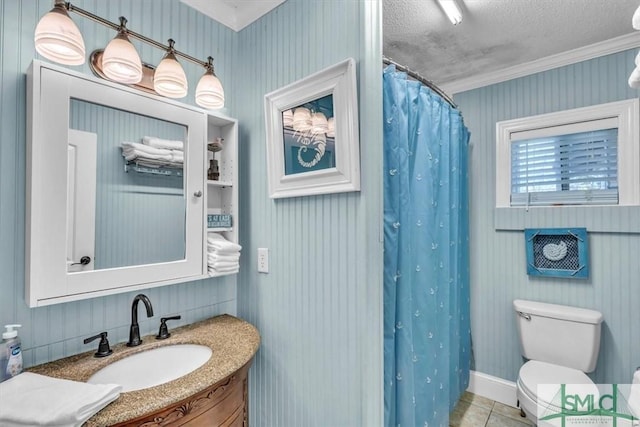 bathroom featuring toilet, vanity, ornamental molding, tile patterned floors, and a textured ceiling