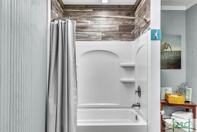 full bath with wooden walls and shower / tub combo with curtain