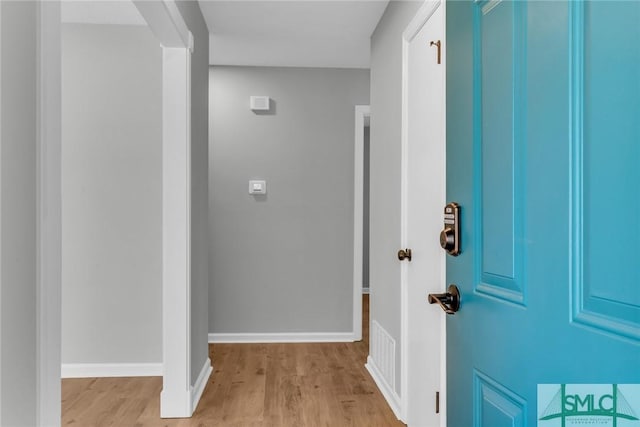 entrance foyer featuring visible vents, baseboards, and wood finished floors