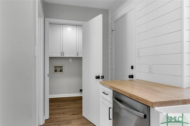 laundry area with laundry area, hookup for a washing machine, baseboards, and wood finished floors