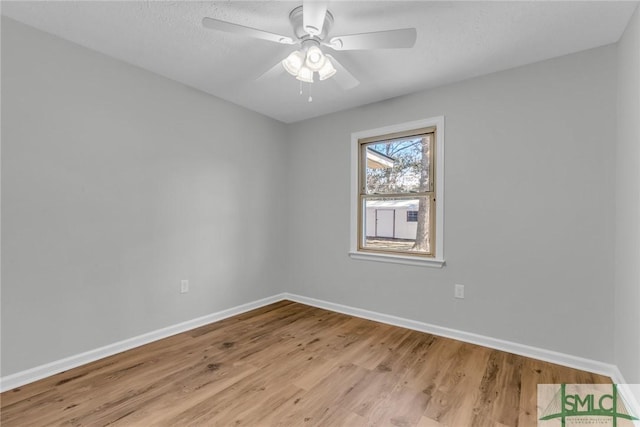 spare room with light wood-style flooring, baseboards, and ceiling fan