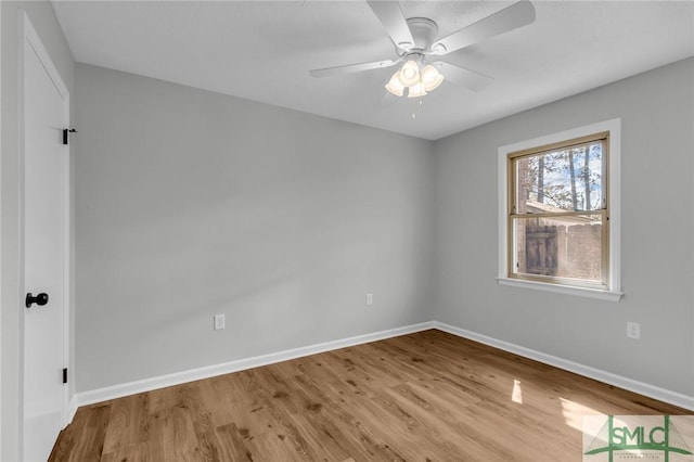 spare room with ceiling fan, baseboards, and wood finished floors