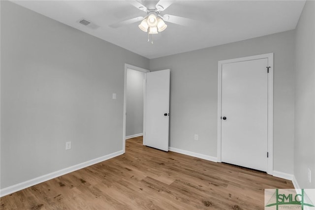 unfurnished bedroom featuring wood finished floors and baseboards