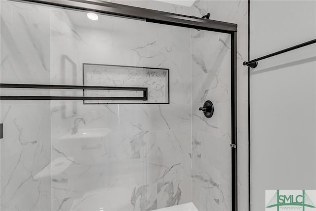 bathroom with a marble finish shower