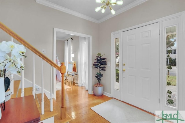 foyer entrance featuring a wealth of natural light, stairway, and ornamental molding