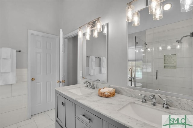 bathroom featuring double vanity, a shower stall, tile walls, and a sink