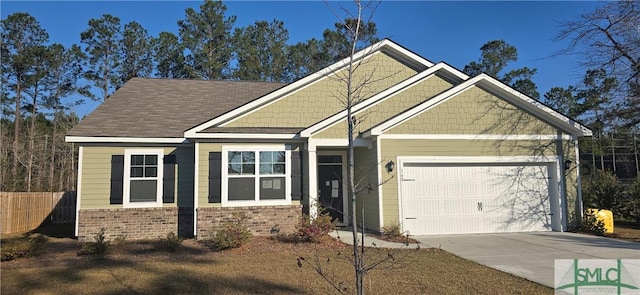 craftsman-style home featuring an attached garage, fence, brick siding, and driveway