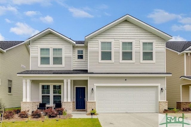 view of front of home with concrete driveway, a garage, brick siding, and covered porch