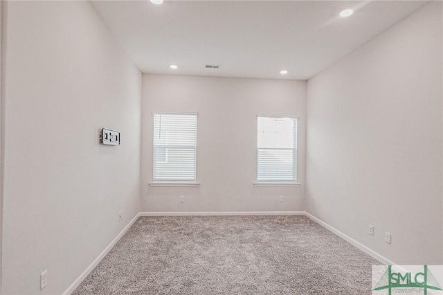 carpeted empty room with recessed lighting, visible vents, and baseboards