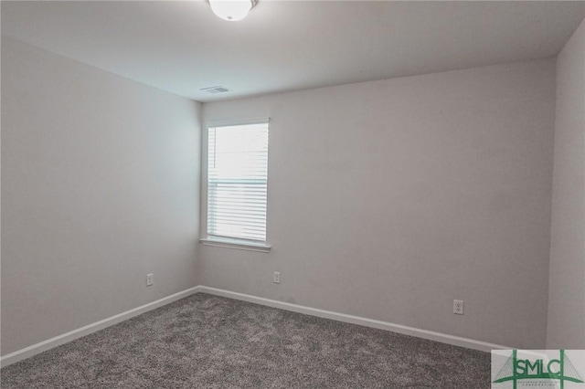 empty room featuring baseboards and carpet