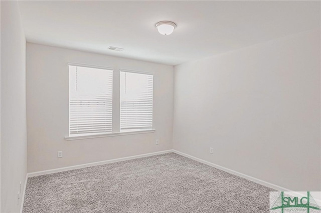 spare room with visible vents, baseboards, and carpet floors