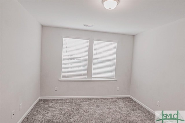 unfurnished room with visible vents, baseboards, and carpet