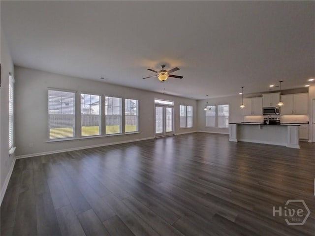 18 Allston Ln, Savannah, GA 31407 - unfurnished living room with dark wood finished floors, baseboards, ceiling fan, and recessed lighting