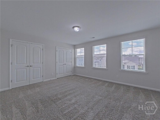 18 Allston Ln, Savannah, GA 31407 - unfurnished bedroom featuring two closets, carpet flooring, and baseboards