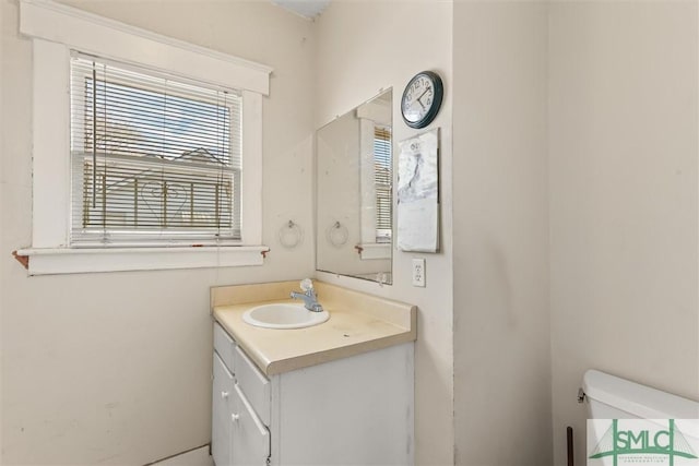 half bath featuring toilet and vanity