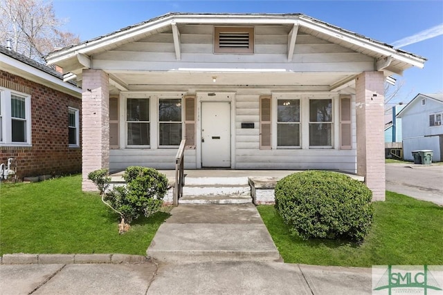 bungalow featuring a porch and a front yard