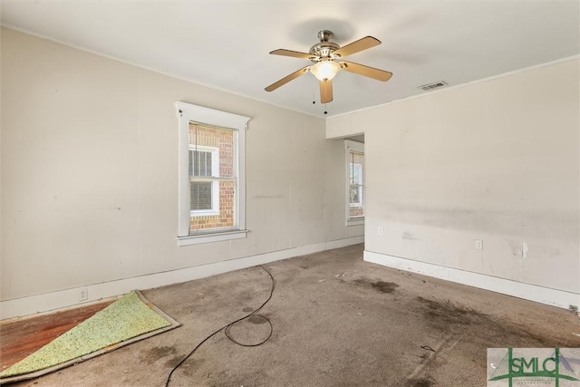 spare room with visible vents, ceiling fan, carpet, and baseboards