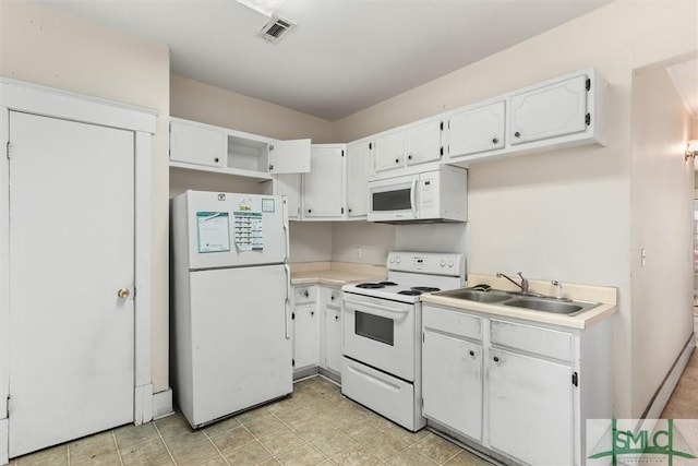 kitchen featuring white appliances, white cabinets, light countertops, and a sink