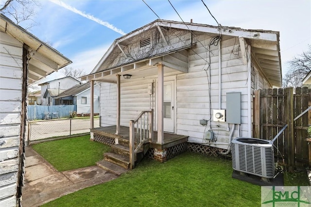 view of outdoor structure with central AC unit and fence