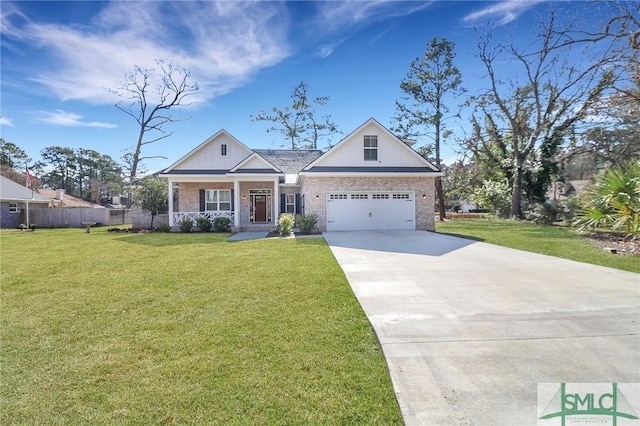 view of front of property with brick siding, an attached garage, a front lawn, covered porch, and driveway