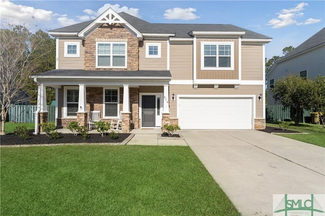 craftsman-style home with stone siding, covered porch, concrete driveway, and a front yard