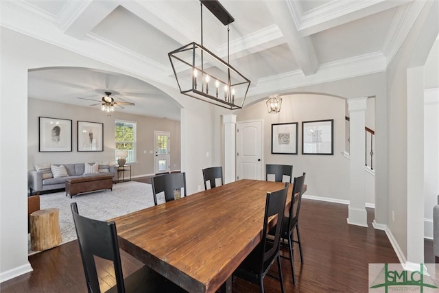 dining space with beam ceiling, coffered ceiling, dark wood-style floors, arched walkways, and baseboards