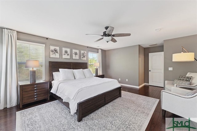 bedroom with baseboards, dark wood finished floors, and a ceiling fan