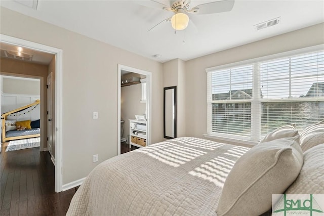 bedroom with visible vents, baseboards, dark wood-style floors, and a ceiling fan