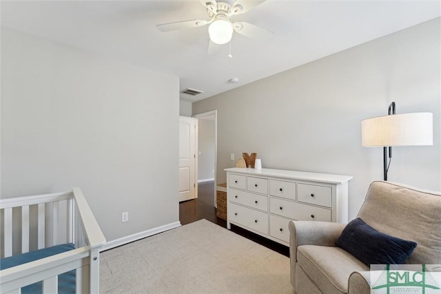 bedroom featuring baseboards, visible vents, dark wood-style flooring, and ceiling fan