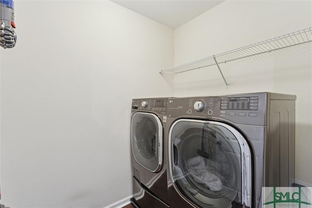 laundry area featuring washer and clothes dryer, laundry area, and baseboards