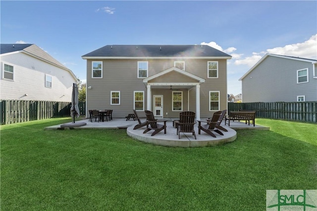 rear view of house featuring a patio area, a lawn, and a fenced backyard