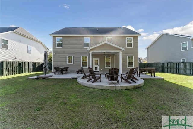 back of house with a patio area, a lawn, an outdoor fire pit, and a fenced backyard