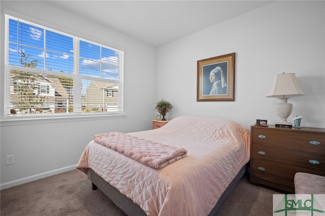 carpeted bedroom featuring baseboards