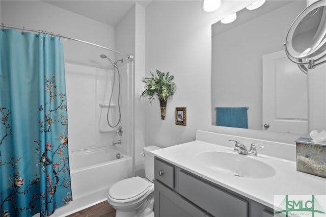 full bathroom featuring wood finished floors, toilet, vanity, and shower / bath combo