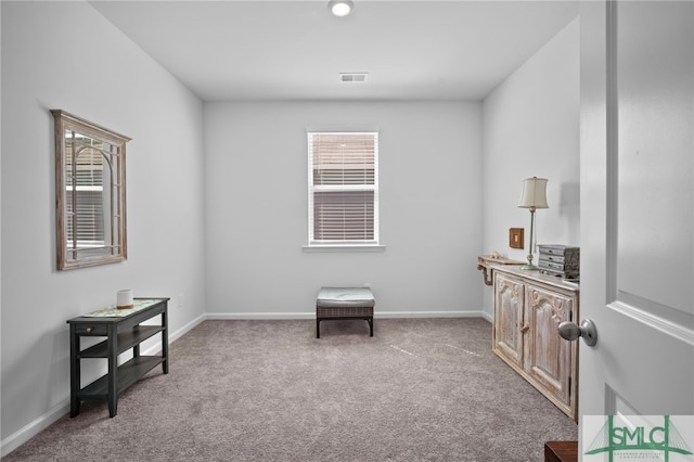 living area with plenty of natural light, baseboards, visible vents, and carpet floors