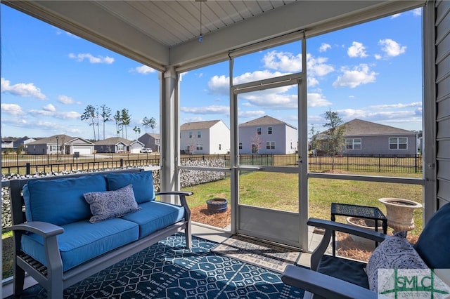 sunroom featuring a residential view